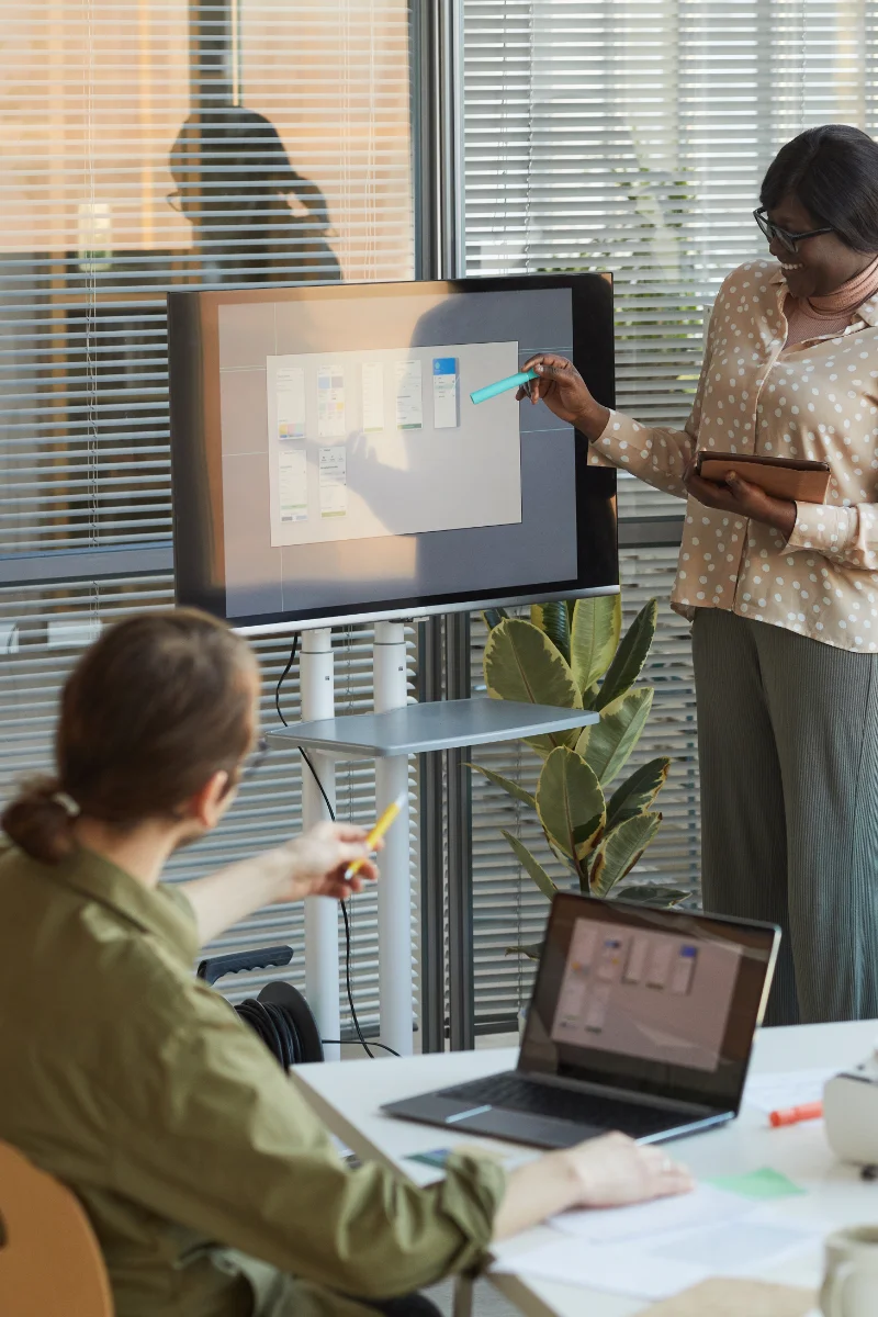 team members collaborating on presentation in office