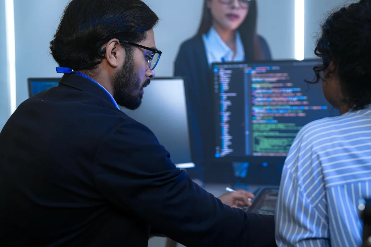 Software developers working in office on code base