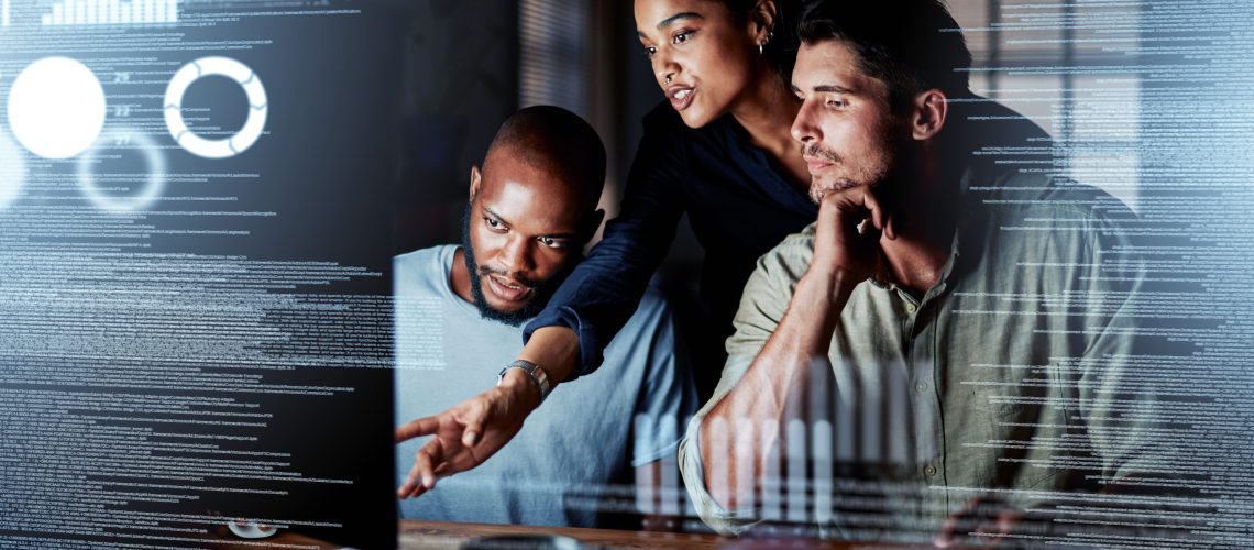 Team of programmers writing digital code in the metaverse and working together on the internet. Group of web designers developing a cybersecurity website, app or software late at night in the office.